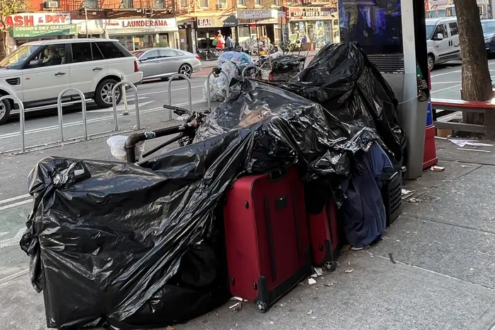 Black garbage bags surround belongings at a homeless encampment in Lower Manhattan